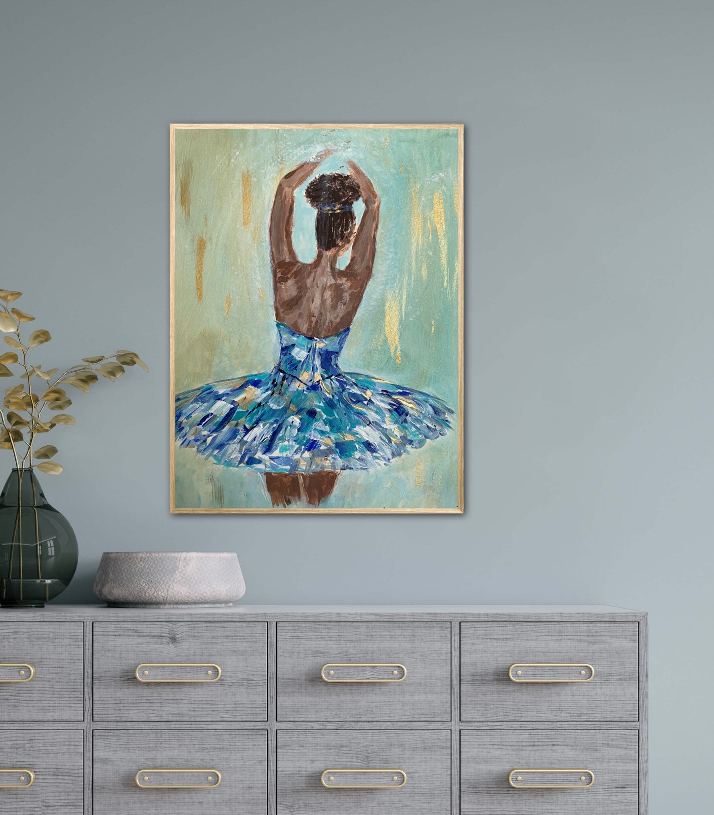 Print featuring black or african american ballerina in blue, aqua, white and gold tutu with soft green background with gold accents in hallway over grey hallway hutch.